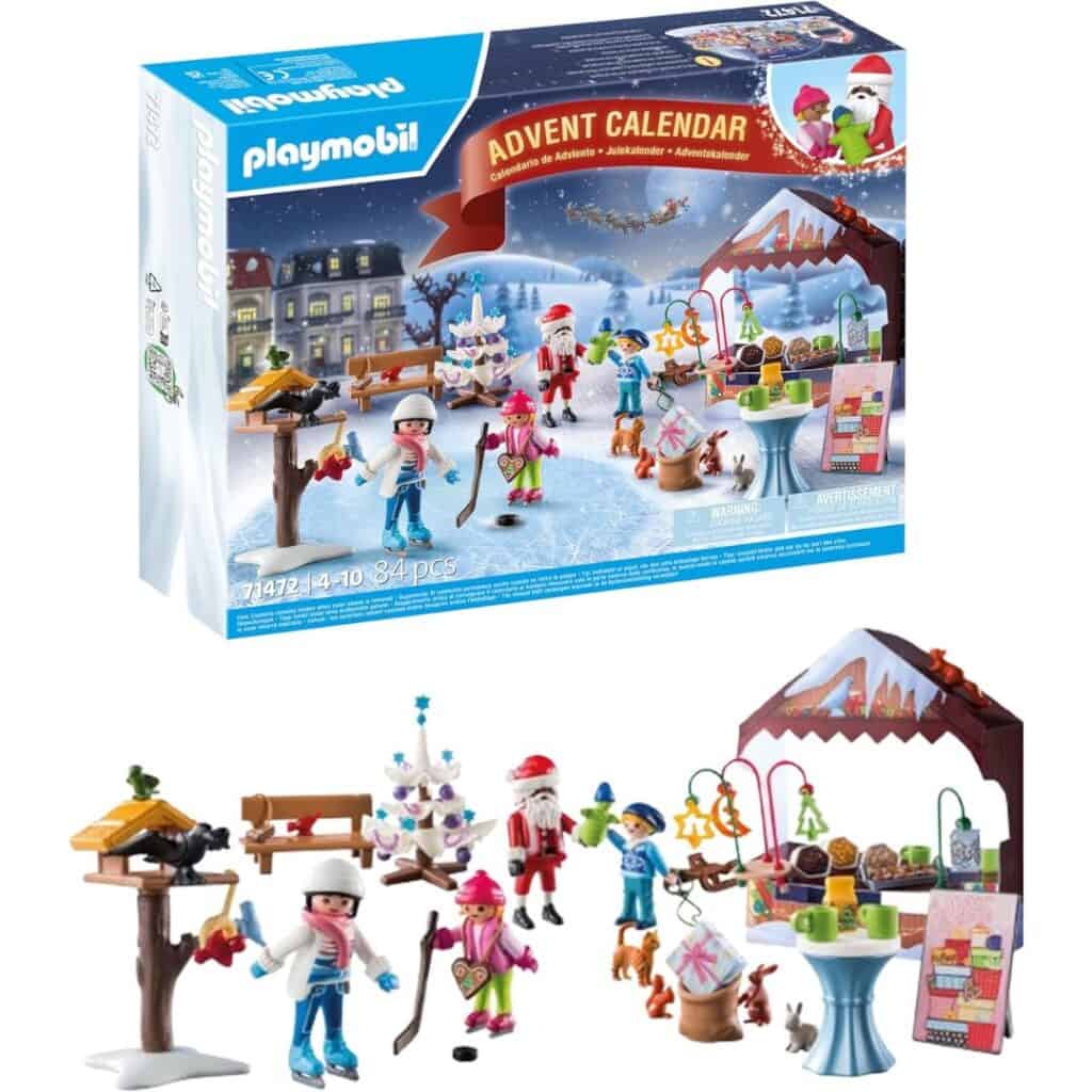 A Playmobil advent calendar set featuring 84 pieces and a festive village scene with mini figures like Santa, ice skaters, and children playing with toys and animals, all under a snowy backdrop.