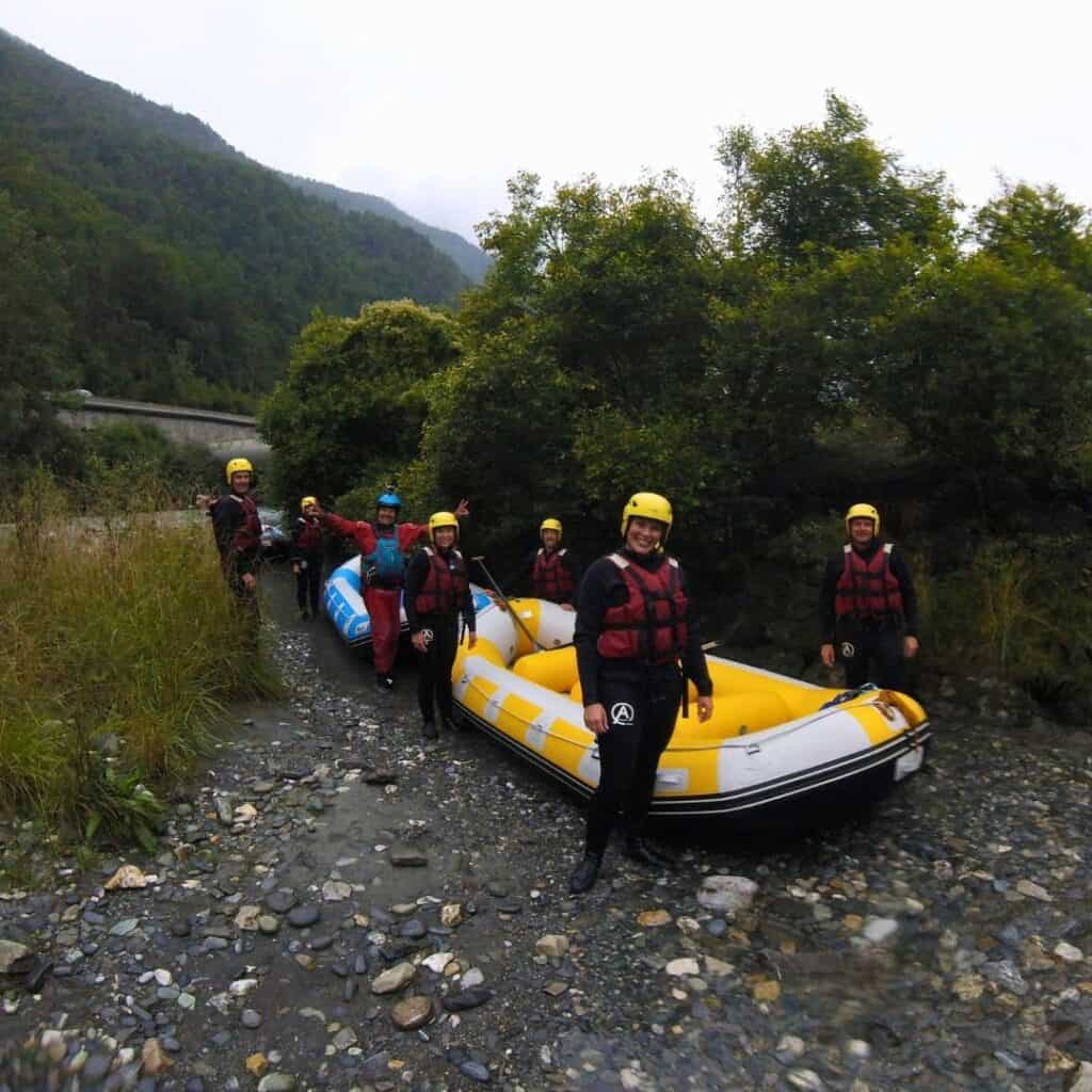 Group preparing to launch on a white water rafting adventure with AN Rafting near La Plagne in the French Alps.