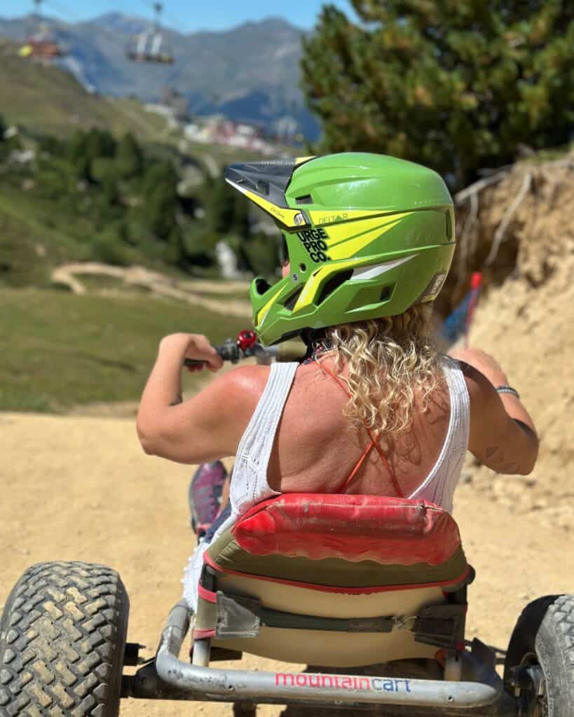 Mountain cart rider in Plagne Centre wearing a full-face helmet on a sunny summer day in La Plagne.