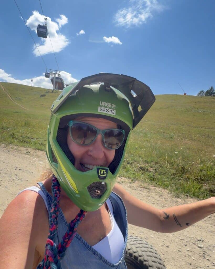 Mountain cart rider in Plagne Centre wearing a full-face helmet on a sunny summer day in La Plagne.