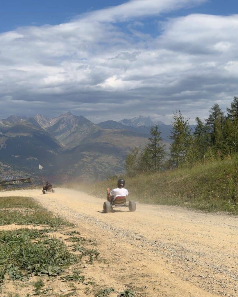 Mountain cart rider descending the long Montalbert track through the forest and mountains of La Plagne.