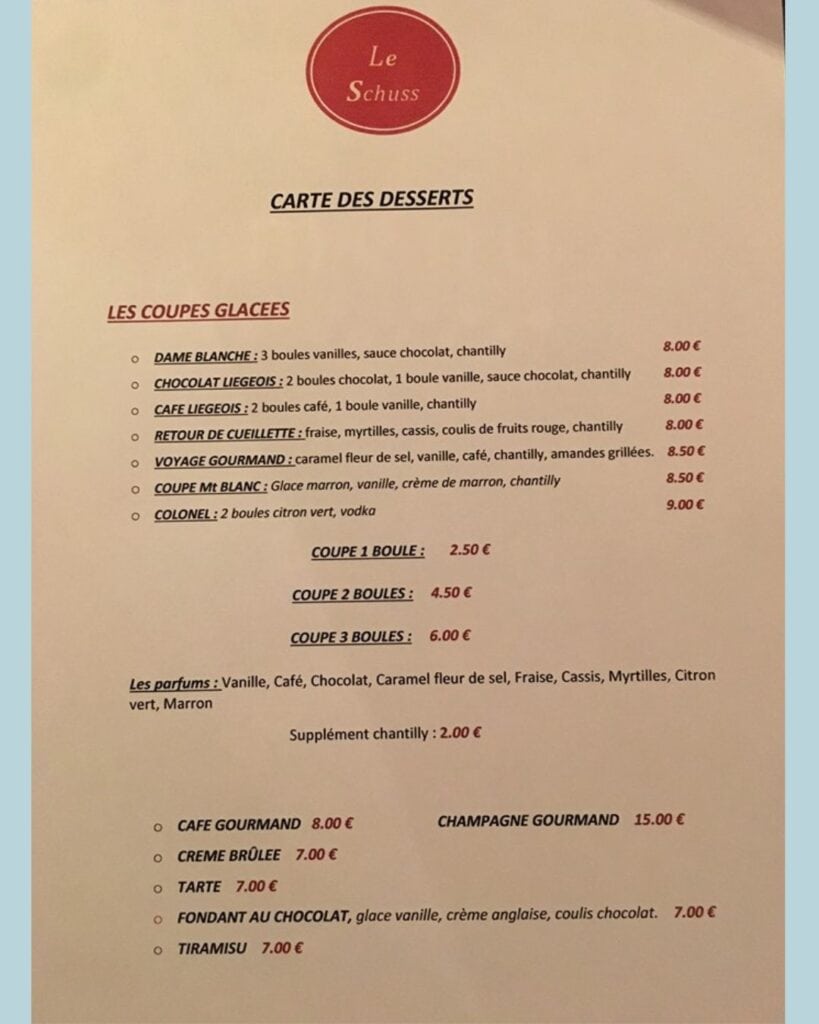 Dessert menu at Le Schuss offering a variety of ice cream sundaes, cakes, and specialties like tiramisu, fondant au chocolat, and crème brûlée, along with ice cream flavors and pricing.