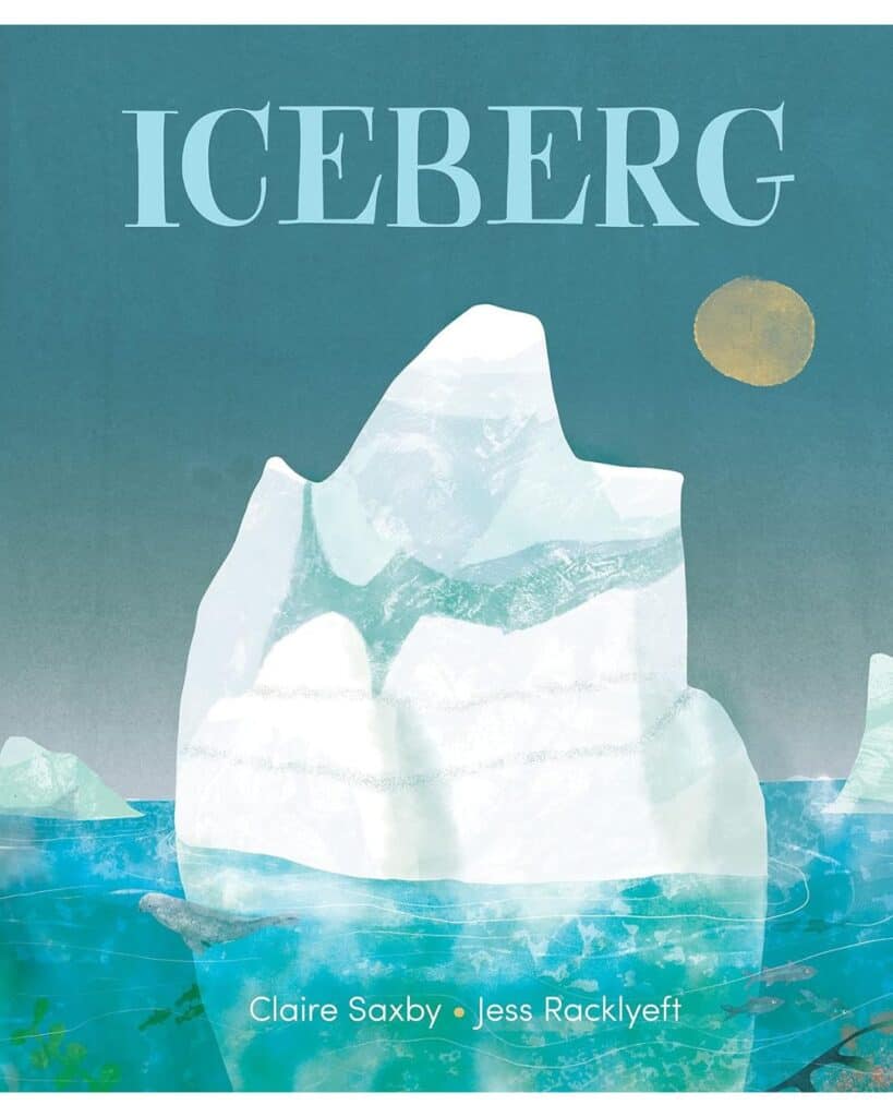 Book cover for Iceberg by Claire Saxby and Jess Racklyeft, featuring a dreamy watercolor-style illustration of a massive iceberg floating in icy blue waters, with a seal swimming below and a golden sun glowing above.