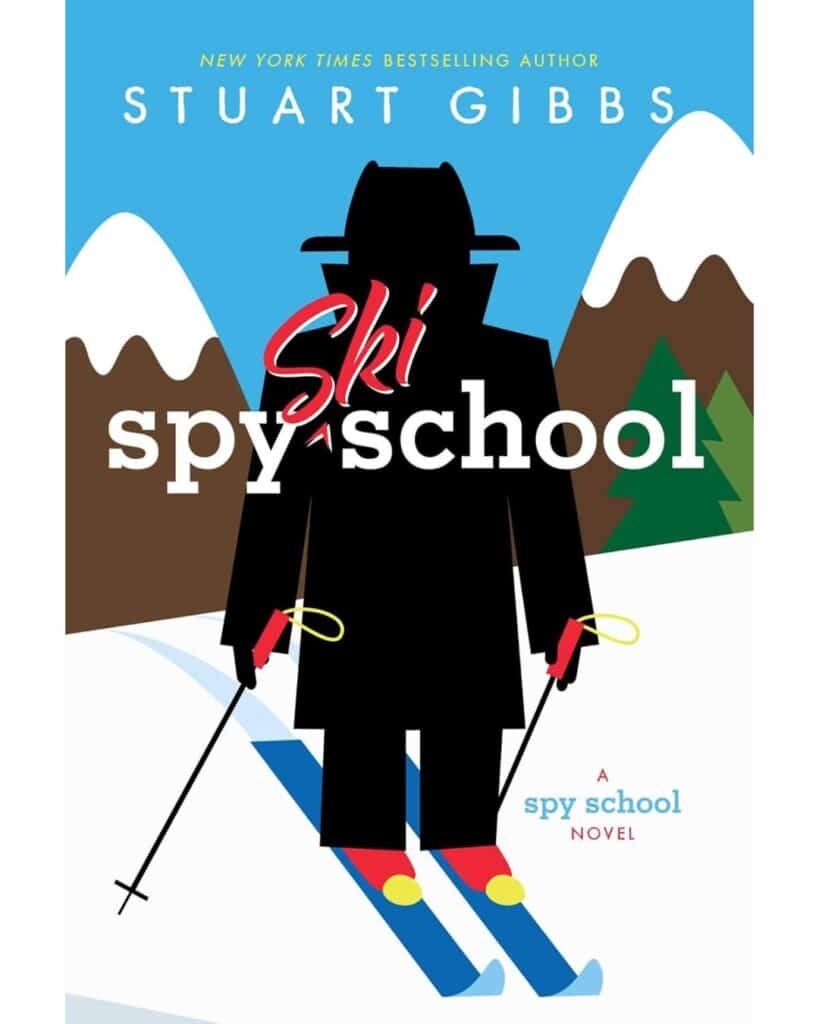 Book cover for Ski Spy School by Stuart Gibbs, designed in minimalist style showing a mysterious black-clad figure in a trench coat and fedora, skiing down a snowy slope with snowy mountain peaks and evergreen trees in the background.