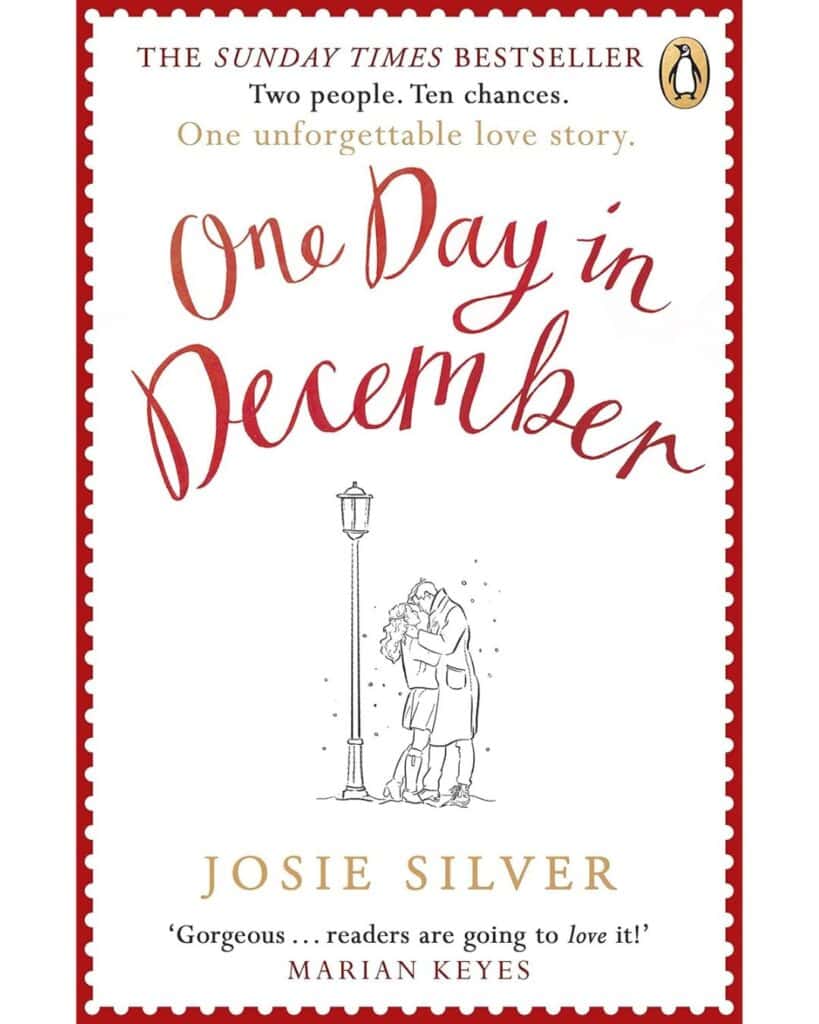 Book cover of One Day in December by Josie Silver, featuring a minimalist white background with a red border, a sketch of a couple kissing under a streetlamp, and romantic tagline text above the title.