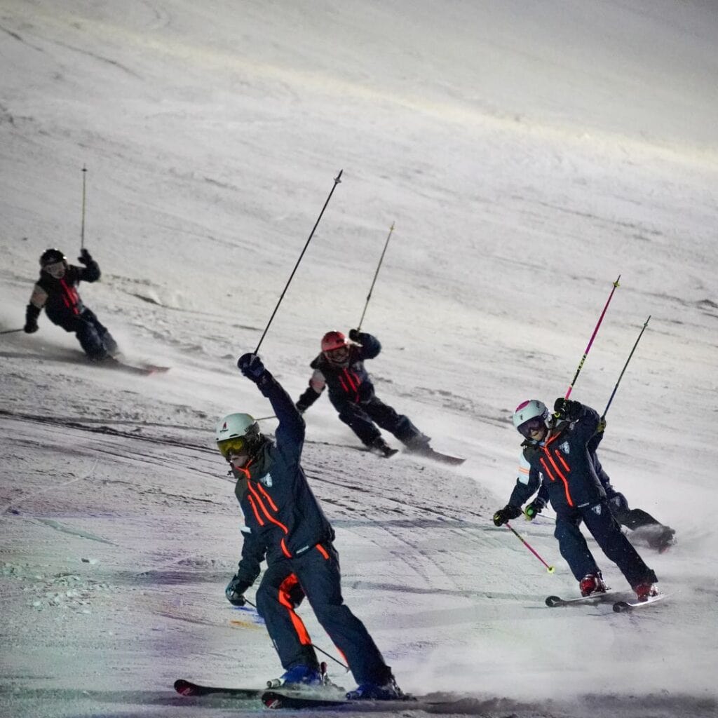 Young members of the La Plagne Club des Sports, aged 8 and above, performing a group ski routine to support their club.