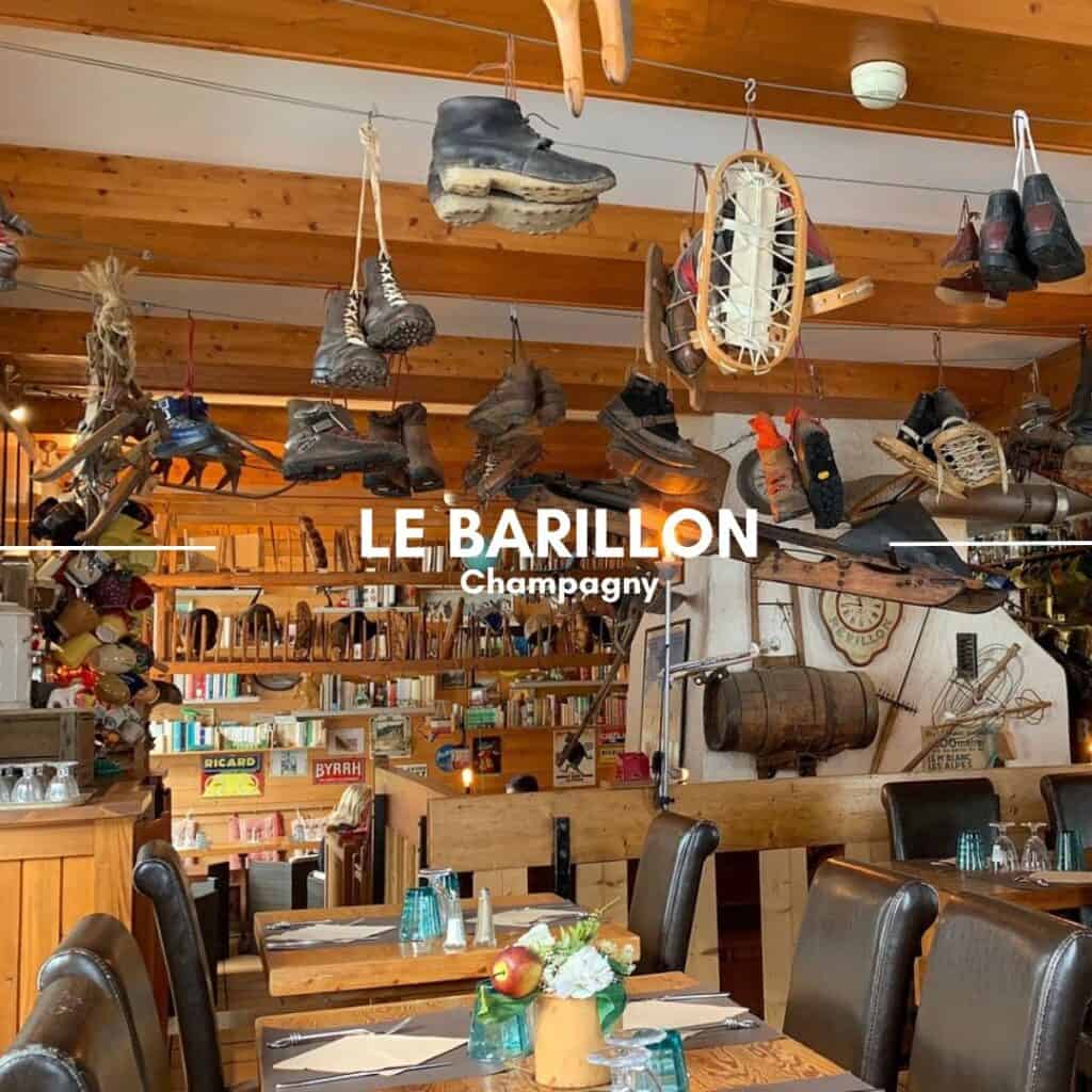 LE BARILLON, Champagny – A quirky, ski-themed restaurant with vintage boots, snowshoes, and rustic decor hanging from the ceiling. The wooden furnishings and bookshelves create a cozy mountain retreat.