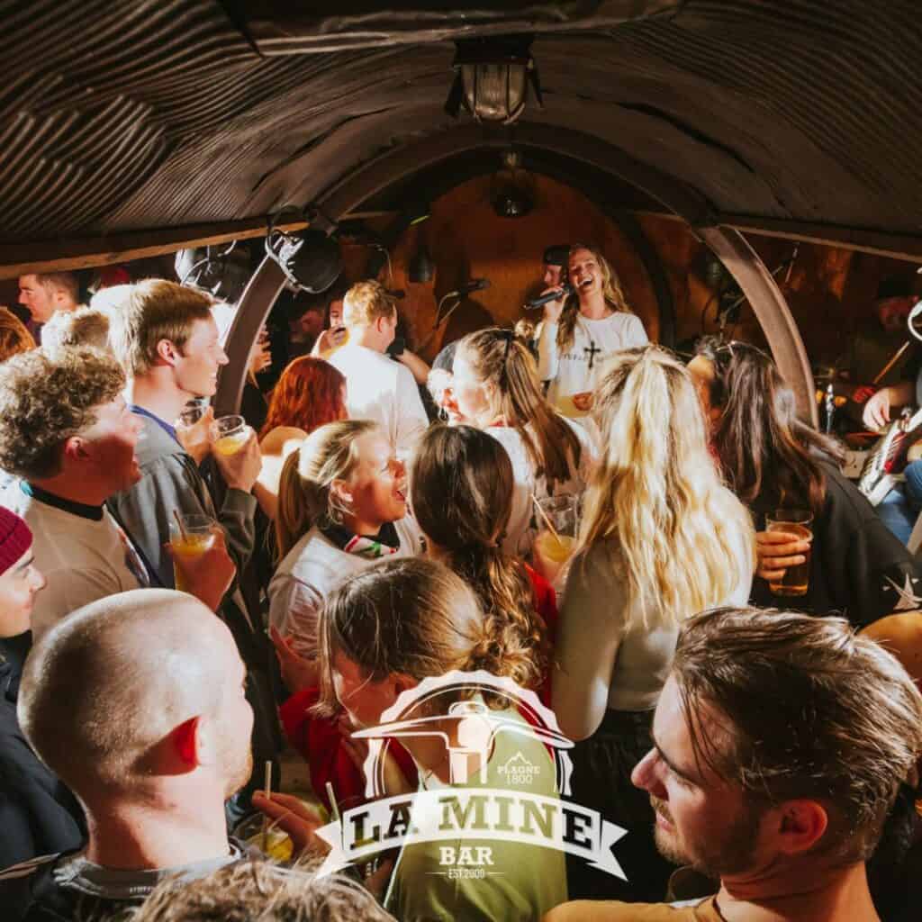 A lively après-ski scene inside La Mine Bar in La Plagne, popular among guests staying in the area’s best social and centrally located accommodation.