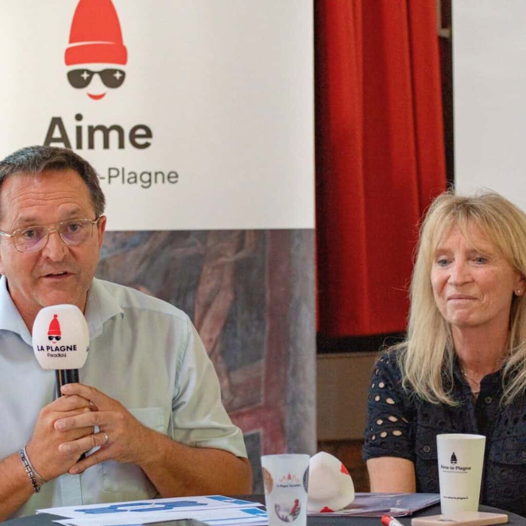 The Mairie from La Plagne Tarentaise and Aime-La-Plagne sit at a discussion table with La Plagne branding behind them, addressing community concerns about the Aime La Plagne gondola and new lift La Plagne plans.