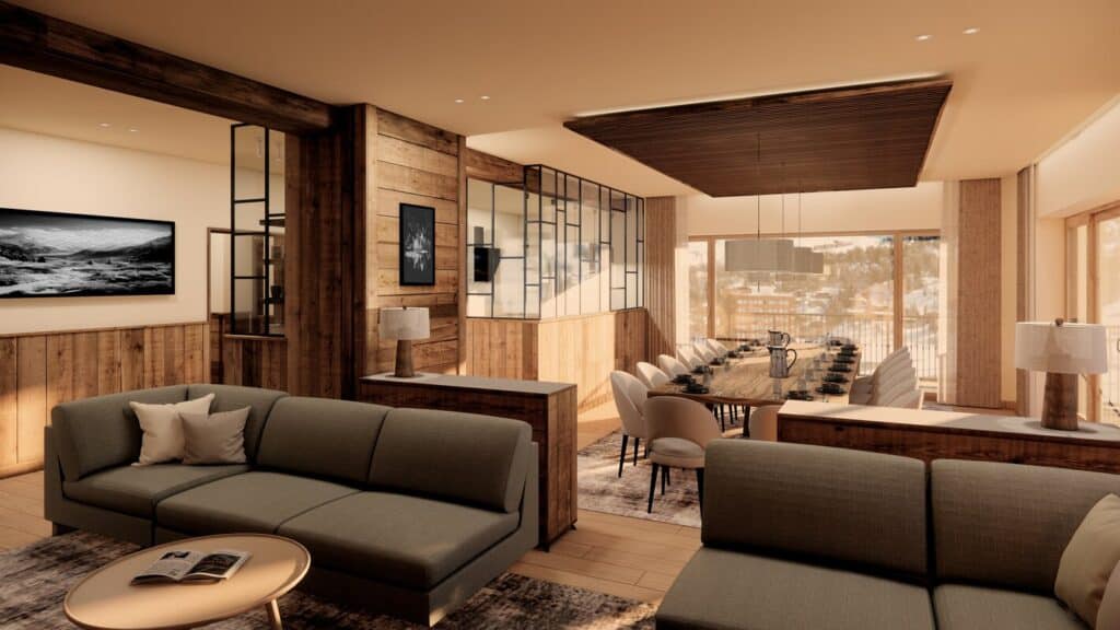 Open-plan living and dining space at Hotel Graciosa in La Plagne, featuring cozy seating, rustic wood finishes, and a long dining table set for guests enjoying a VIP SKI chalet experience.