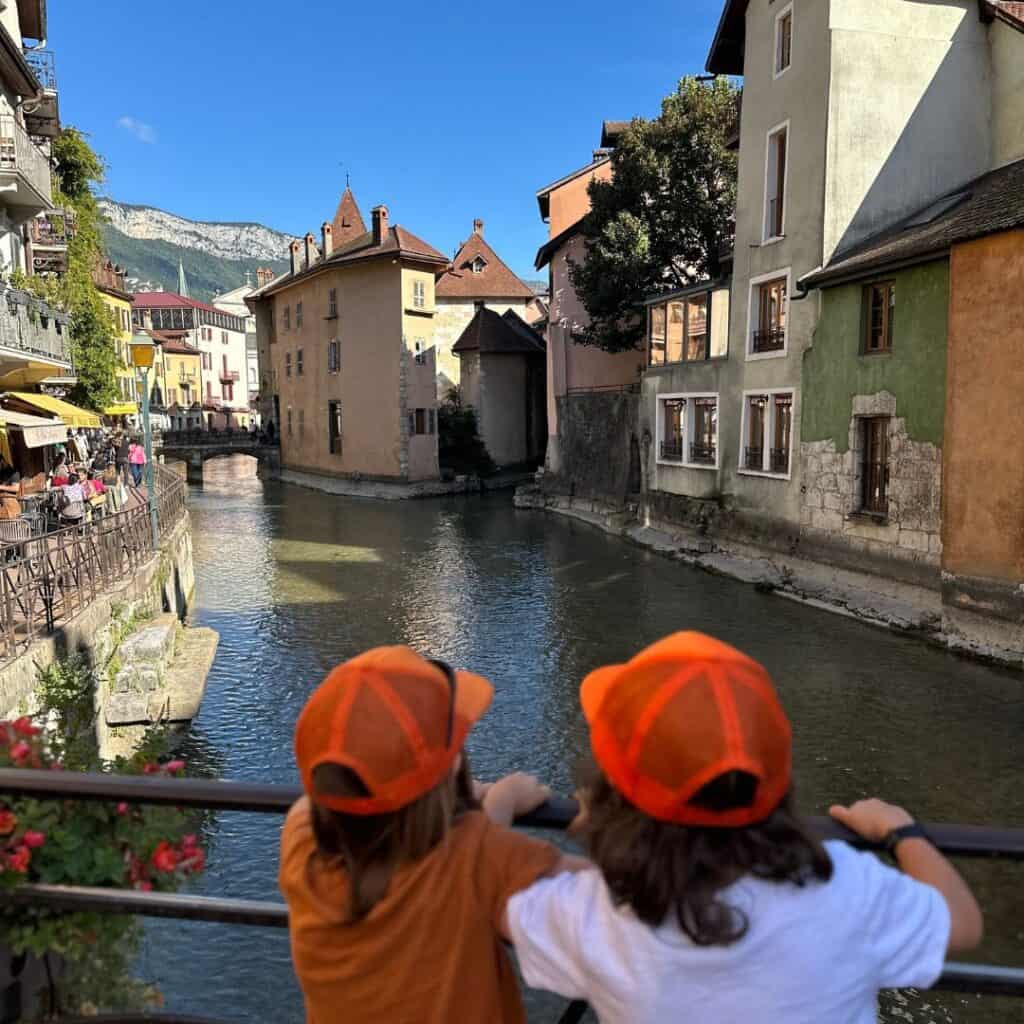 old town. Pastel buildings, cafés, and mountain views create a postcard scene in the French Alps.