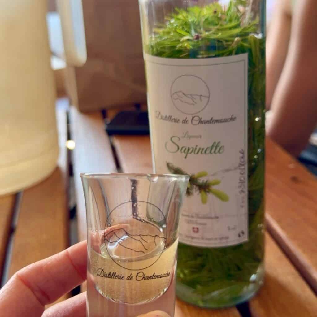 Homemade bottle of Sapinette made from foraged fir shoots at Distillerie de Chantemouche.