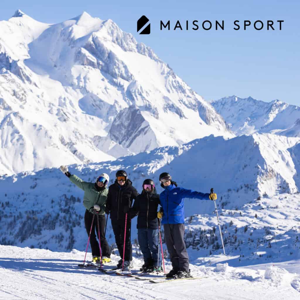 Maison Sport ski instructor with a group of skiers in La Plagne, with snowy Alpine mountains in the background